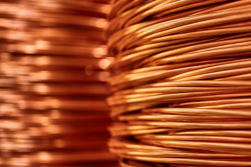 Shiny colorful winded thick copper cable at bright light in warehouse of contemporary equipment production plant extreme closeup
